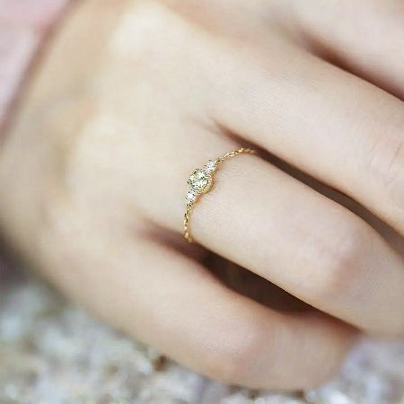 A classic solitaire-style ring with a central stone, included in the adjustable chain ring set.