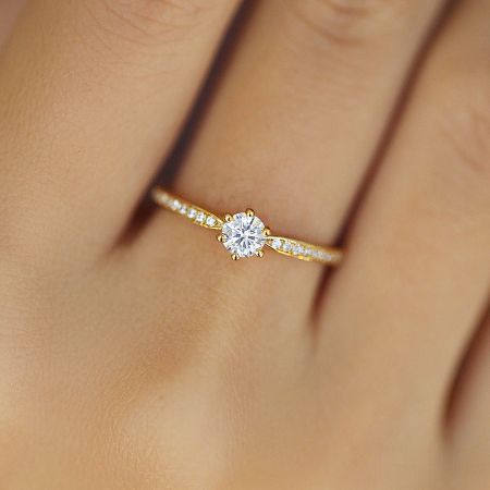 Angled view of the classic gold-plated sterling silver solitaire ring against a neutral background.
