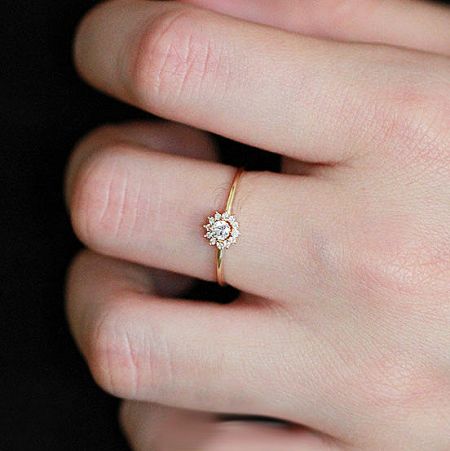 Angled shot of the gold-plated sunflower ring showcasing its brilliant centerpiece.