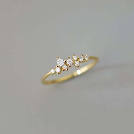 A stylish gold-plated ring showcasing a unique cluster design of cubic zirconia stones.