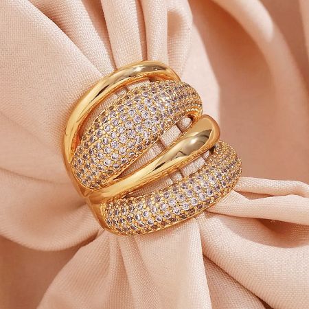 Side profile of a chunky gold plated dome ring, highlighting the sparkling cubic zirconia pave.