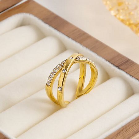 A single gold zircon ring from the set displayed in a wooden box.