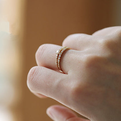 A delicate gold-plated sterling silver zircon ring worn on a finger, highlighting its elegant design for everyday wear.