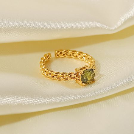 Close-up of the adjustable open ring with a vibrant green cubic zirconia stone.