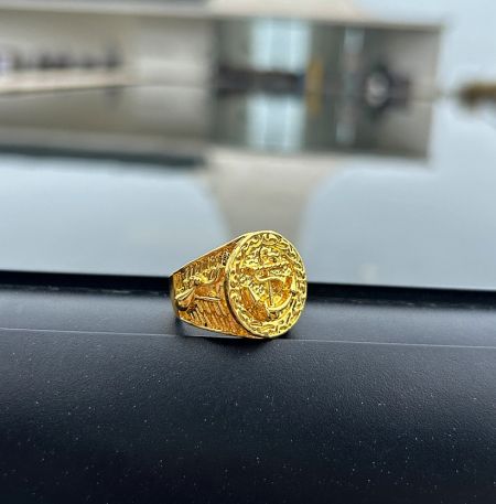 Side view of the gold plated stainless steel ring, highlighting the detailed patterns on the band.