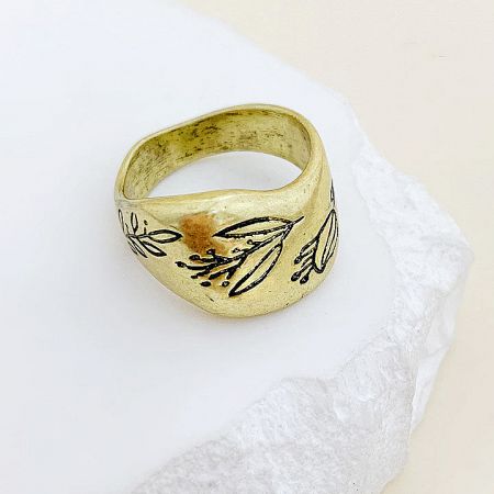 A gold-colored brass ring with a continuous leaf pattern.
