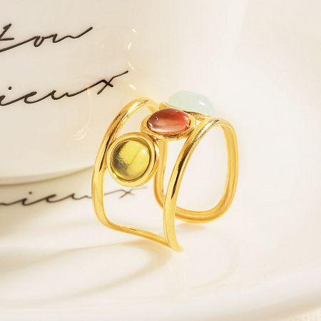 Detailed view of a cuff ring with multi-colored stones.
