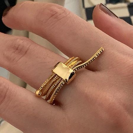 Close-up of the gold adjustable chain ring showcasing its multi-band design.