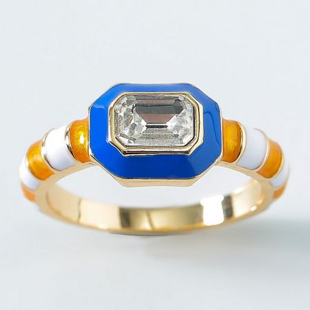 Close-up of a gold-plated enamel ring with a prominent octagonal gemstone.