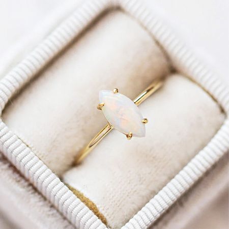 A detailed view of the marquise-shaped white opal solitaire ring from the stackable set.
