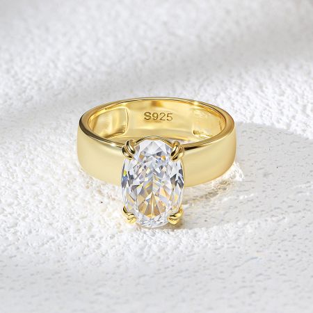 The S925 sterling silver stamp visible inside the band of the gold-finished engagement ring.