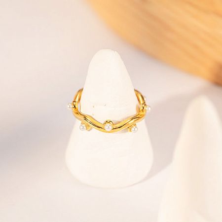 Product shot of the stainless steel gold irregular wave ring with pearls.