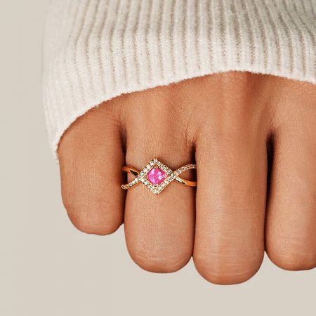 Angled view of the elegant pink zircon ring showcasing its intertwined band design.