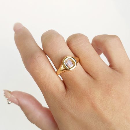 Close-up of the signet ring with a vibrant pink square CZ stone.