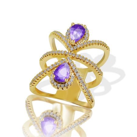 Angled view of the wide gold plated ring, emphasizing the sparkle of the purple and white cubic zirconia.