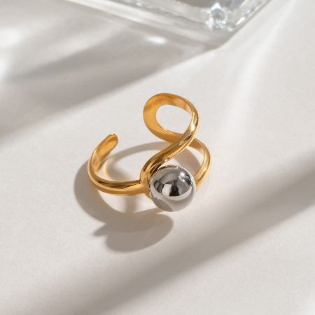 Side profile of the gold plated ring showing the open, adjustable band and swirl design.