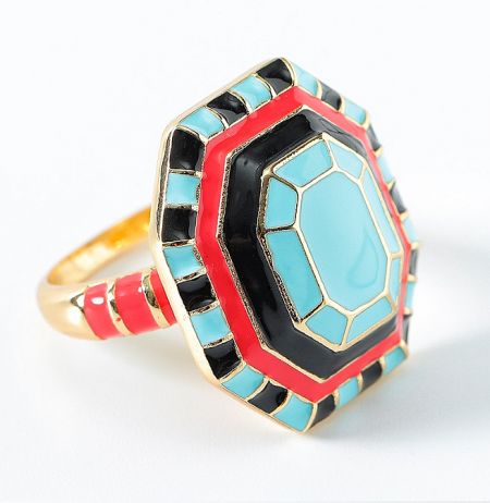 Detailed view of a gold ring featuring intricate turquoise enamel work.