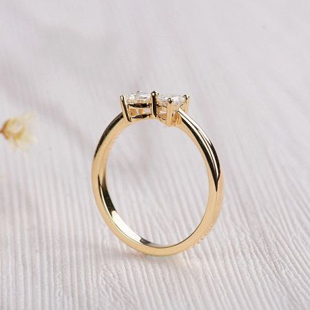 Detailed view of the 18K gold plated double heart ring with clear cubic zirconia gemstones.