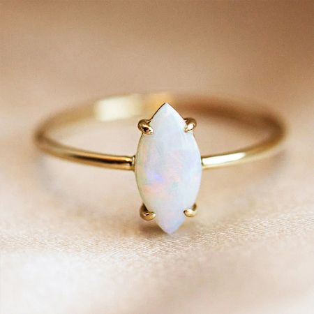 Another perspective of the beautiful marquise-cut white opal ring, highlighting its sparkle.