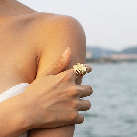 Lifestyle shot of a woman wearing one of the gold vintage rings from the set.