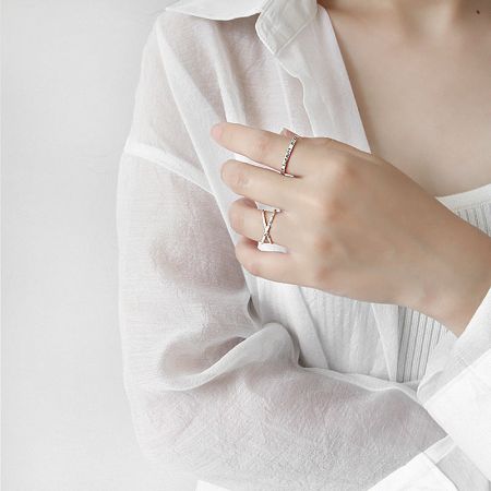 A model's hand displaying the stylish crossover sterling silver rings, reflecting the latest Korean fashion trends.