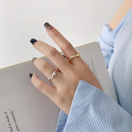 Model wearing the set of minimalist 925 sterling silver adjustable rings for a stacked look.