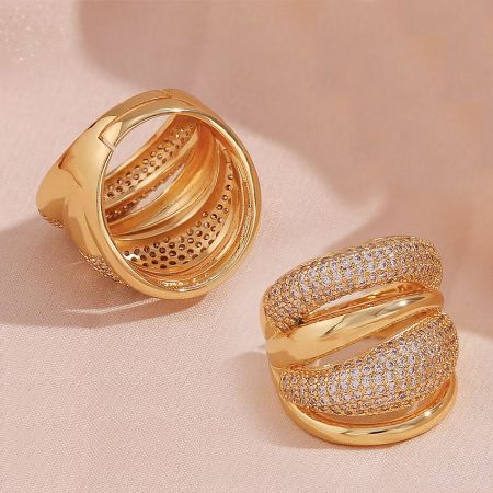 Detailed view of the 18K gold plated CZ chunky rings, showing both plain and paved layers.