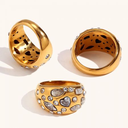 A collection of three gold plated pave zircon rings, showing variations in the set.