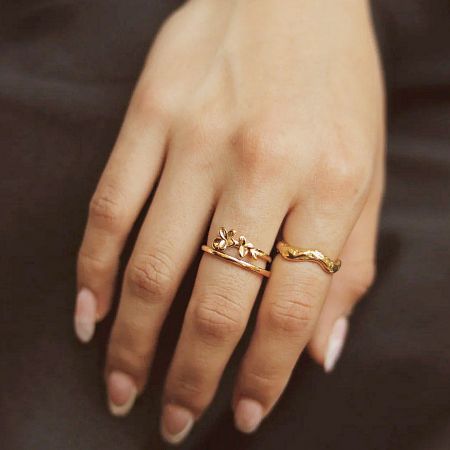 The floral ring styled with another wavy gold band to showcase stacking possibilities.