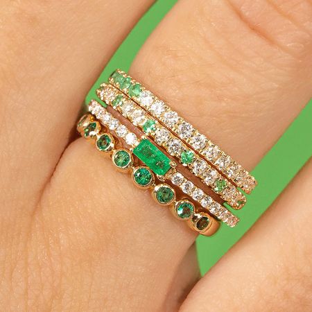Close-up view of the green and white zircon crystal sterling silver rings stacked on a finger.