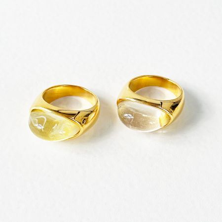 Side-by-side comparison of the stainless steel rings with yellow and white opal stones.