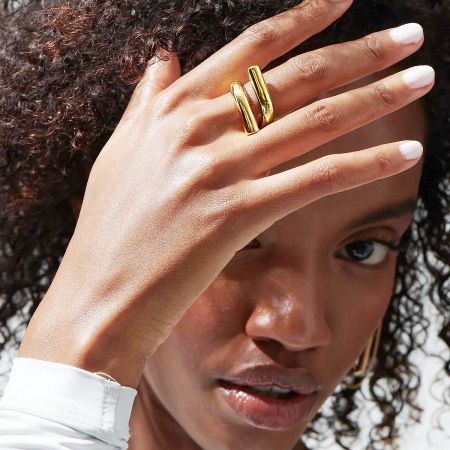 A model wearing the gold geometric stainless steel rings to showcase their look.