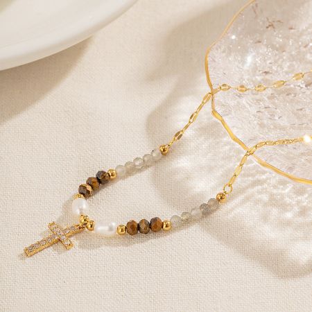 Detailed view of the beaded chain and crucifix pendant, highlighting the craftsmanship.