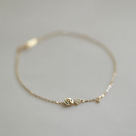 Another perspective of the tiny rose flower charm bracelet, highlighting its delicate design.