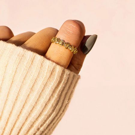 A model wearing the Eternal Bloom gold-plated rose ring on her finger to display its elegant fit.