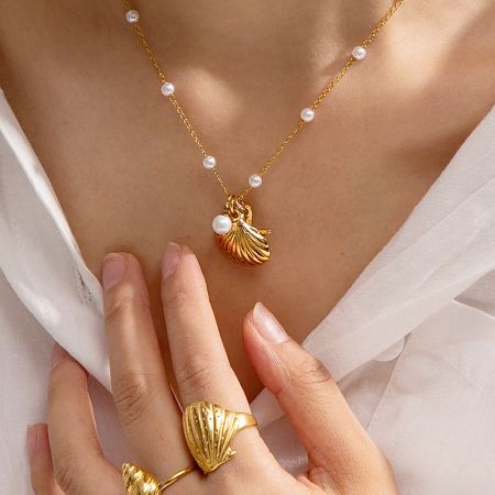 The complete beach jewelry set, including the gold seashell necklace and a matching ring.