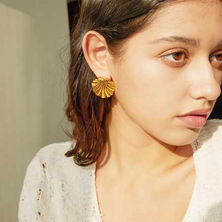 Promotional product shot of the gold seashell earrings, highlighting their elegant design.