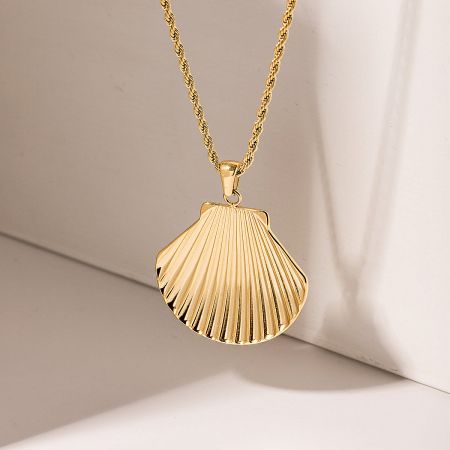Detailed view of the gold seashell pendant and twisted rope chain.