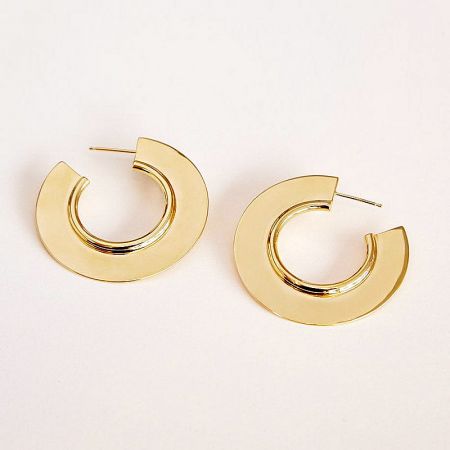 Close-up product shot of the geometric C hoop earrings in a polished gold finish.