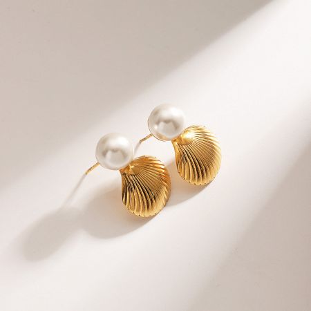 Pair of gold shell earrings with pearl accents.