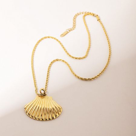 Side view of the gold shell pendant necklace showcasing its lustrous finish.
