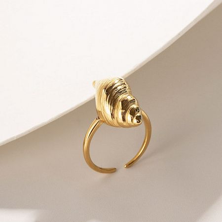 Detailed product shot of a gold shell-inspired ring.