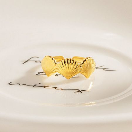 The shell ring elegantly displayed on a decorative plate.