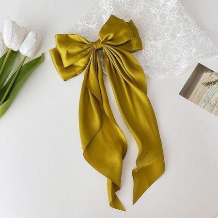 A luxurious gold-colored long-tail bow hair clip.