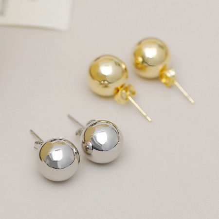 Gold and silver metallic ball stud earrings shown together for comparison.