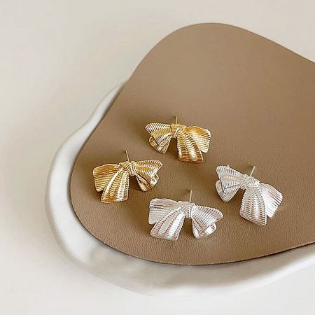 925 Sterling Silver Metallic Bowknot Stud Earrings (Set of 5 Pairs) - A set of 925 sterling silver metallic bowknot stud earrings in both gold and silver finishes, displayed on a textured surface.