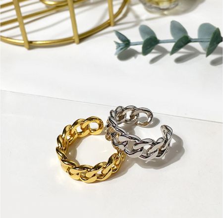 A gold and a silver version of the chain link ring, showcasing material options.
