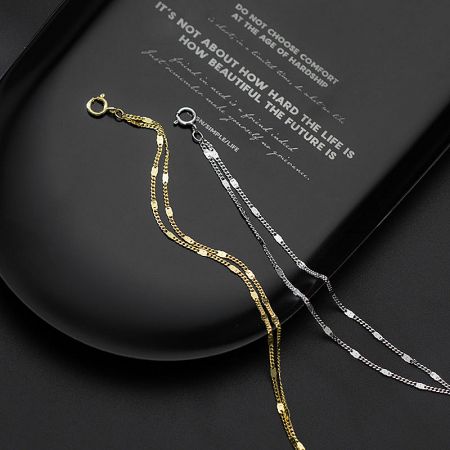 Product shot of the gold and silver chain bracelets.