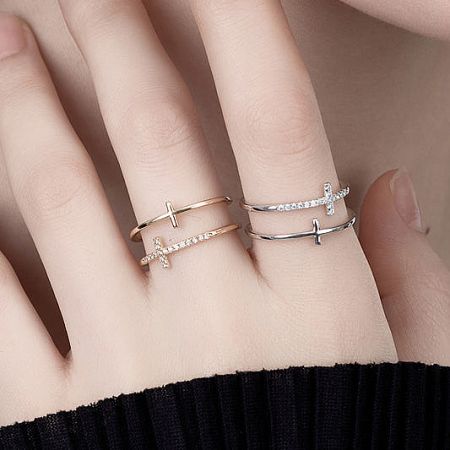 925 Sterling Silver Rings Collection - A stunning collection of 925 sterling silver rings by JR Fashion Accessories, showcasing various cross and diamond designs in both gold and silver finishes on a model's hand.