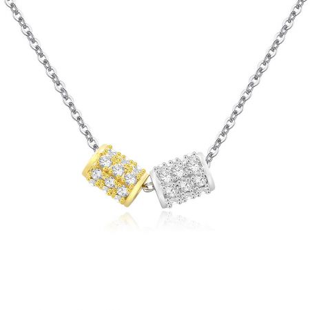 Detailed view of the gold and silver pendants with cubic zirconia.